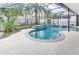Relaxing screened in pool and spa with waterfall feature at 2804 Polson Dr, Kissimmee, FL 34758