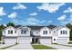 Three-unit townhome building with attached garages and neutral color scheme at 520 Astera Winds Ln, Lake Mary, FL 32746