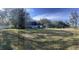 Spacious backyard with large grassy area and home in background at 6611 Hereford Dr, Lakeland, FL 33810