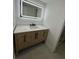 Modern bathroom with a sleek vanity and illuminated mirror at 6611 Hereford Dr, Lakeland, FL 33810