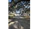 House with a long driveway, three-car garage, and landscaping at 6611 Hereford Dr, Lakeland, FL 33810