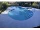 Freeform swimming pool with concrete decking and steps at 6611 Hereford Dr, Lakeland, FL 33810
