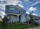 Two-story house with light blue siding, white trim, landscaping, and a two-car garage at 13467 Panama Beach Ct, Orlando, FL 32827