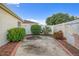 Small, paved backyard with landscaping and a fence at 17090 Se 76Th Caledonia Ter, The Villages, FL 32162