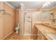 Bathroom with walk-in shower and granite countertop at 17090 Se 76Th Caledonia Ter, The Villages, FL 32162