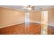Bedroom with tile floors, ceiling fan, and access to bathroom at 17090 Se 76Th Caledonia Ter, The Villages, FL 32162