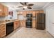 Modern kitchen with wood cabinets and granite countertops at 17090 Se 76Th Caledonia Ter, The Villages, FL 32162
