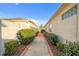 Landscaped side yard with a walkway and fence at 17090 Se 76Th Caledonia Ter, The Villages, FL 32162