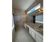 Double sink bathroom with a large mirror and window at 3323 Songbird Ln, Lakeland, FL 33811