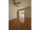 Bright bedroom with laminate wood floors and access to a screened porch at 3323 Songbird Ln, Lakeland, FL 33811