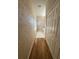 Long hallway with light wood floors and neutral walls at 3323 Songbird Ln, Lakeland, FL 33811