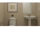 Simple, clean bathroom with pedestal sink and neutral tones at 7013 Rosy Sky Ave, Orlando, FL 32829