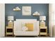 Bedroom with white crib, neutral decor, and cloud shelves at 7018 Rosy Sky Ave, Orlando, FL 32829