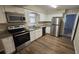 Renovated kitchen, featuring granite countertops and stainless steel appliances at 5716 Deerfield Rd, Orlando, FL 32808