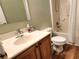 Clean bathroom with single sink vanity, toilet and bathtub shower combo at 169 Vista View Ave, Eagle Lake, FL 33839