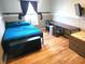 Bedroom with built-in desk, full-size bed, and wood-look flooring at 169 Vista View Ave, Eagle Lake, FL 33839