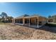 House exterior showcasing covered patio, screened porch, and spacious backyard at 769 Marion Oaks Manor, Ocala, FL 34473