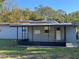 Ranch style home exterior with covered porch at 1224 10Th St, Holly Hill, FL 32117