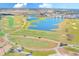 Aerial view of golf course, lake, and community at 1369 Palmetto Dunes St, Davenport, FL 33896
