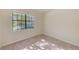 Well-lit bedroom with a large window and carpet flooring at 1369 Palmetto Dunes St, Davenport, FL 33896