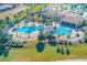 Large community pool with lounge chairs and palm trees at 1369 Palmetto Dunes St, Davenport, FL 33896