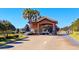 Gated entrance to a community with palm trees and landscaping at 1369 Palmetto Dunes St, Davenport, FL 33896