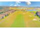 Aerial view of a lush golf course with nearby residential homes at 1369 Palmetto Dunes St, Davenport, FL 33896