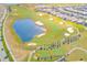 Aerial view of a beautiful golf course with a pond and residential homes at 1369 Palmetto Dunes St, Davenport, FL 33896