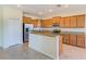 Kitchen with wood cabinets, granite countertops, and stainless steel appliances at 1369 Palmetto Dunes St, Davenport, FL 33896