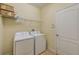 Laundry room with washer, dryer, and overhead shelving at 1369 Palmetto Dunes St, Davenport, FL 33896