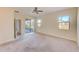 Large bedroom with carpet, sliding doors to backyard, and ensuite bathroom at 1369 Palmetto Dunes St, Davenport, FL 33896