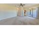 Spacious Primary bedroom with carpet and access to patio at 1369 Palmetto Dunes St, Davenport, FL 33896