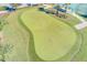 Expansive putting green with multiple flags for practicing at 1369 Palmetto Dunes St, Davenport, FL 33896