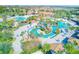 Aerial view of expansive resort pools, a lazy river, and plenty of lounge space at 1369 Palmetto Dunes St, Davenport, FL 33896