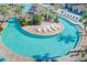 Relaxing resort-style pool with a lazy river and plenty of lounge chairs at 1369 Palmetto Dunes St, Davenport, FL 33896