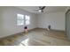 Bedroom with ceiling fan, large window, and wood-look floors at 4706 Kimball W Ct, Lakeland, FL 33813