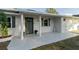 Inviting front porch with tile flooring and modern columns at 4706 Kimball W Ct, Lakeland, FL 33813