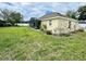 Exterior of a house with a screened patio, fenced backyard, and green lawn at 506 Alleria Ct, Auburndale, FL 33823