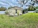 Home exterior with a screened-in porch, grassy lawn, and decorative plants at 506 Alleria Ct, Auburndale, FL 33823