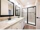 Elegant bathroom boasts dual vanities, a glass-enclosed shower, and modern fixtures at 7837 Somersworth Dr, Kissimmee, FL 34747