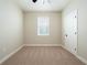 Cozy bedroom with neutral walls, plush carpeting, and ample natural light at 7837 Somersworth Dr, Kissimmee, FL 34747