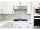 Modern kitchen featuring white shaker cabinets, stainless steel appliances, and a gas cooktop at 7837 Somersworth Dr, Kissimmee, FL 34747