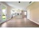 Open-concept kitchen and dining area with white cabinets, stainless steel appliances, and wood-look flooring at 7837 Somersworth Dr, Kissimmee, FL 34747