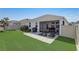 Private backyard with a screened-in patio, artificial turf, and a paved patio area at 1767 Bee Nice Dr, Kissimmee, FL 34744