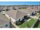 Aerial view of a home with a screened-in patio, fenced yard, and surrounding homes at 1767 Bee Nice Dr, Kissimmee, FL 34744