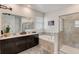 Elegant bathroom with double vanity, soaking tub, and walk-in shower at 1767 Bee Nice Dr, Kissimmee, FL 34744