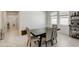 Dining area adjacent to the kitchen, featuring a table, chairs, and bar cart at 1767 Bee Nice Dr, Kissimmee, FL 34744