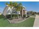Side view of a home featuring stone accents, blue shutters, and a two-car garage at 1767 Bee Nice Dr, Kissimmee, FL 34744