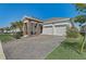 Single-Gathering home with a stone and stucco exterior, a covered entryway, and a two-car garage at 1767 Bee Nice Dr, Kissimmee, FL 34744