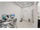 Bright home office with two desks, computers, and a view of the front door at 1767 Bee Nice Dr, Kissimmee, FL 34744